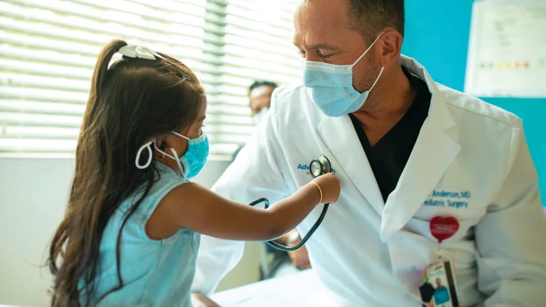 Doctor with pediatric patient in office 