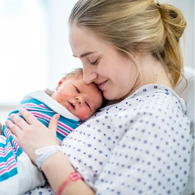 A mom holding her newborn.