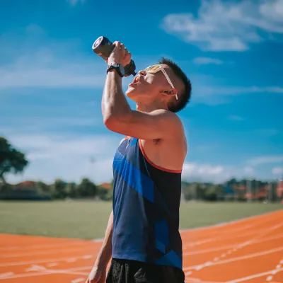 A young, asian adult on a water break