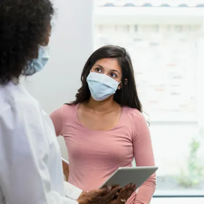 A patient listening to her provider with attention
