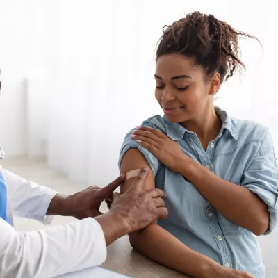 A Doctor Put on a Bandage After Giving an Injection