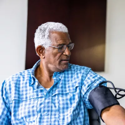 A Patient Has His Blood Pressure Taken By a Nurse in a Practice.