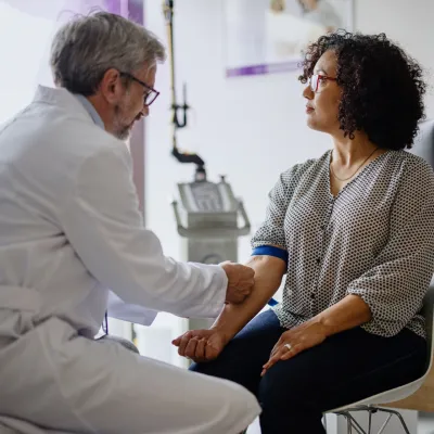 A Doctor Prepares His Patient's Arm for a Blood Draw.
