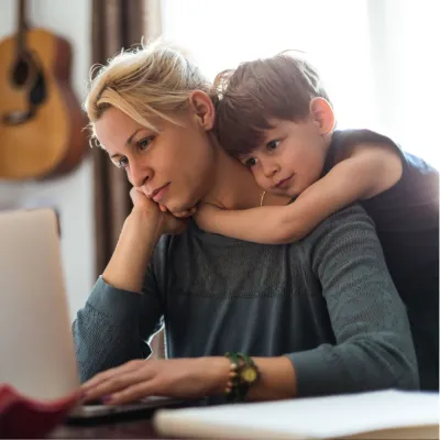 A Son Hugs His Mother While She Tries to Find Help on the Internet