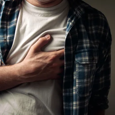 Man clutching his chest.