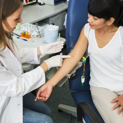 Woman prepares to have her blood drawn