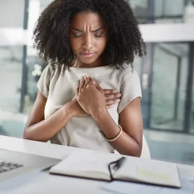 A young woman experiencing chest pain.