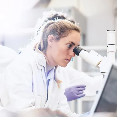 Doctor looking into a microscope