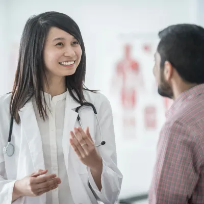 Doctor smiling and speaking with a patient