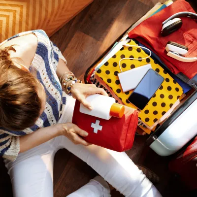 An Over Head Shot of a Woman Packs For a Visit to the Hospital