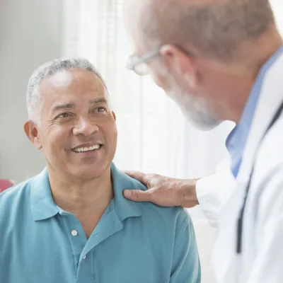 Blue Shirt Hispanic Man with Caucasian Doctor