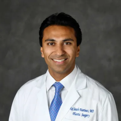 A professional headshot of Dr. Raj Martinez
