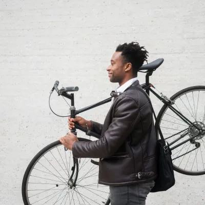 A man carries his bike after riding to work
