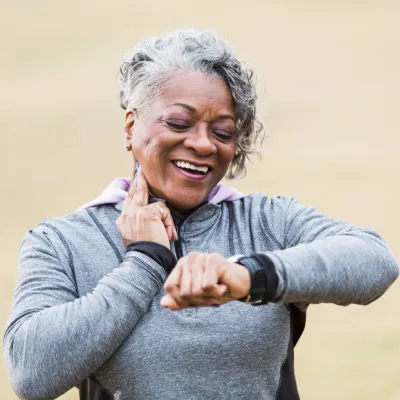 Female runner checking her wearable device