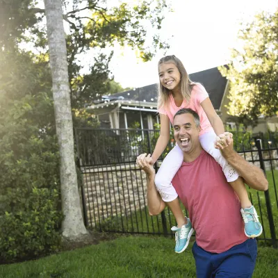 a man with a child on his shoulders