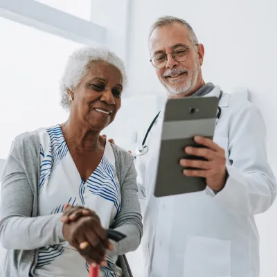 Senior woman patient talking with male doctor.
