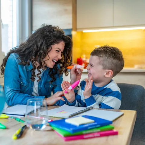 Mother and Son HAve Fun Coloring and Learning at the Kitchen Table