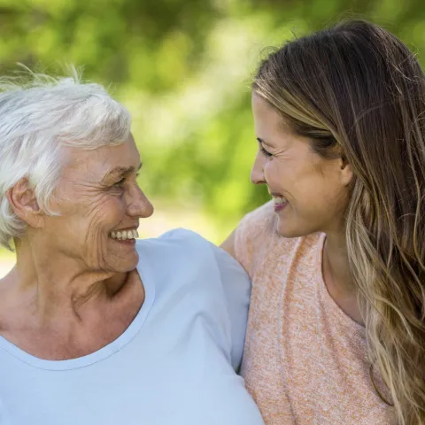 Two women smiling and hugging.