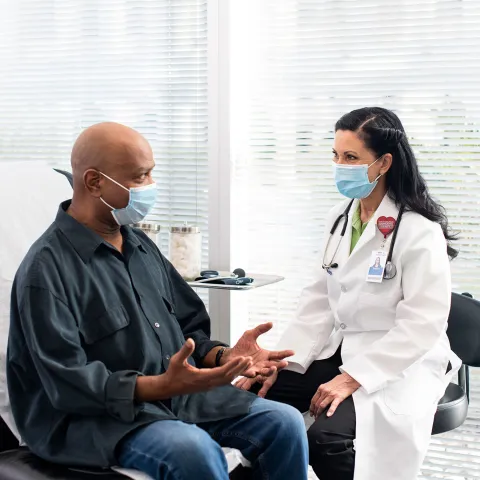 An AdventHealth doctor talking with a patient of color