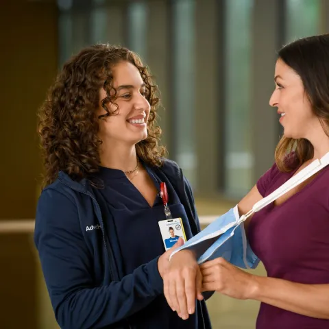 A female healthcare worker and female patient.