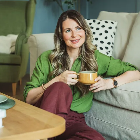 A middle-aged woman drinking coffee.