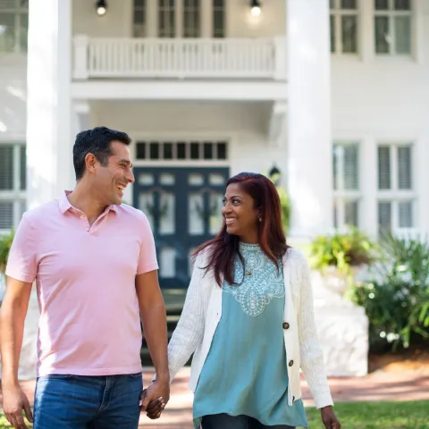 Happy Hispanic Couple walking together outdoors