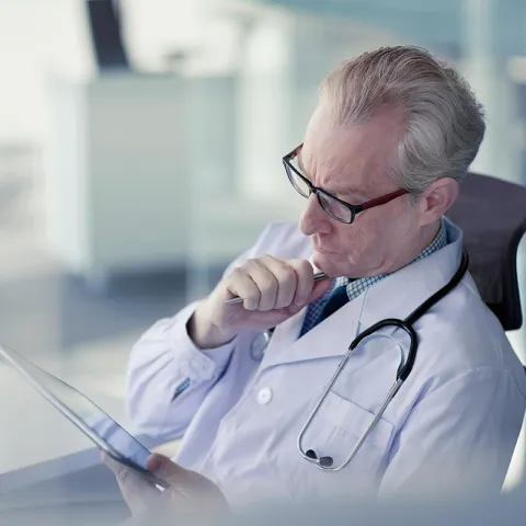 Doctor reading from an ipad tablet