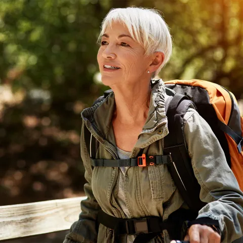 Older female backpacker out for a hike