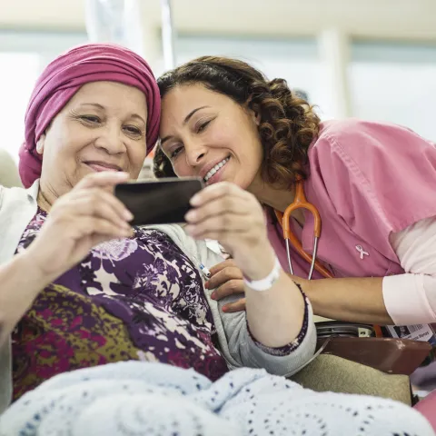 A young nurse and her female cancer patient taking a sweet selfie.