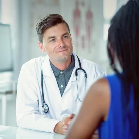 Doctor sitting at a table with a patient