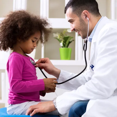 A little girl gets a check up at her doctor's office.
