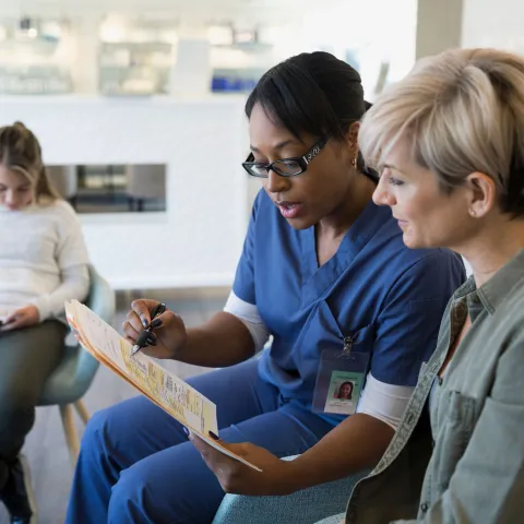 A woman reviews her test results with her doctor.