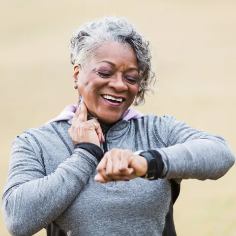 Female runner checking her wearable device