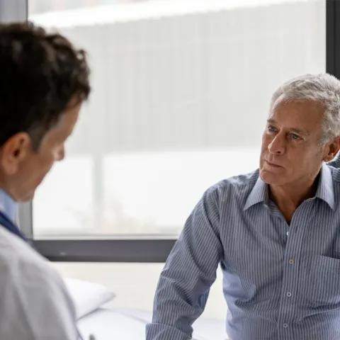 Older Man talking his doctor about Aquablation.