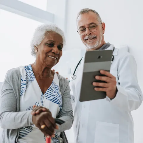 Senior woman patient talking with male doctor.