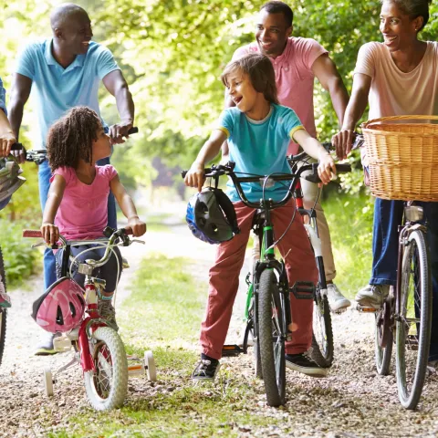 Multigenerational family riding bikes together.