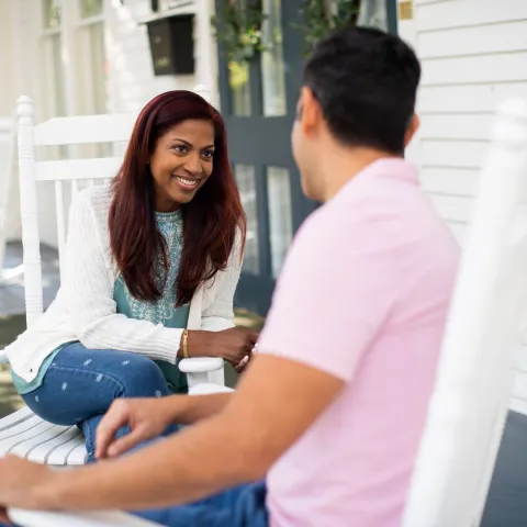 Smiling couple sitting outdoors