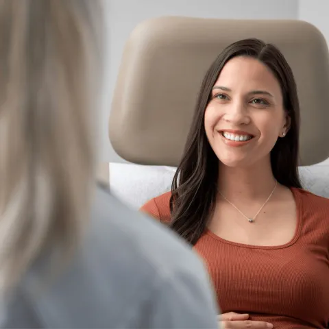 A female patient smiling at her healthcare provider.