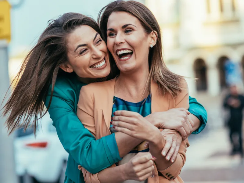 Two joyful women laughing.
