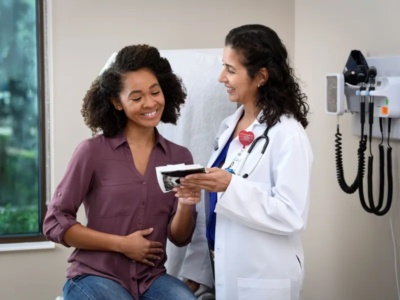 Young Pregnant Woman With Doctor