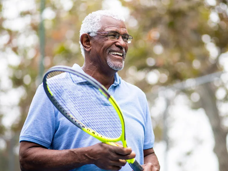 Man holding a tennis raquet  