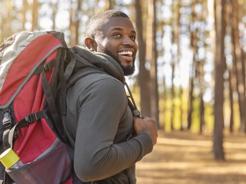 A man hiking in the woods. 