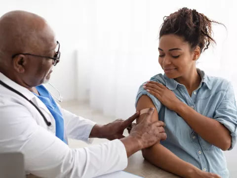 A Doctor Put on a Bandage After Giving an Injection