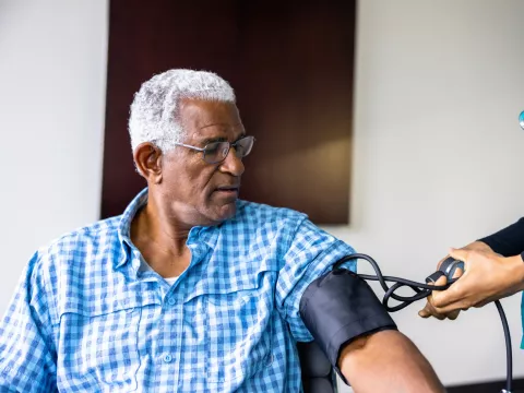A Patient Has His Blood Pressure Taken By a Nurse in a Practice.