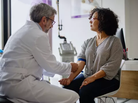 A Doctor Prepares His Patient's Arm for a Blood Draw.