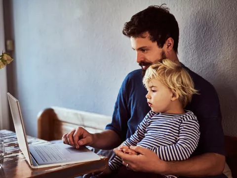 A Father and Son Sit and Surf the Internet From Home.