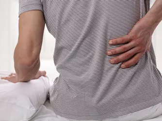 Man holding aching back.