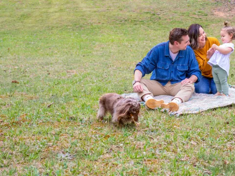 Family playing in yard together.