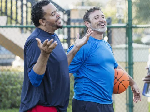 Group of men staying healthy playing basketball