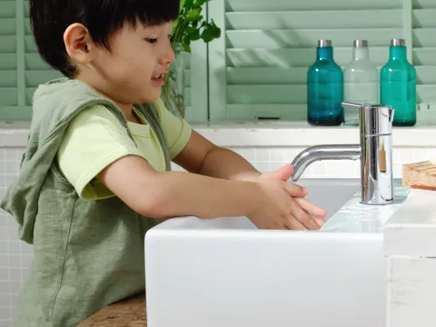 Little boy washing his hands